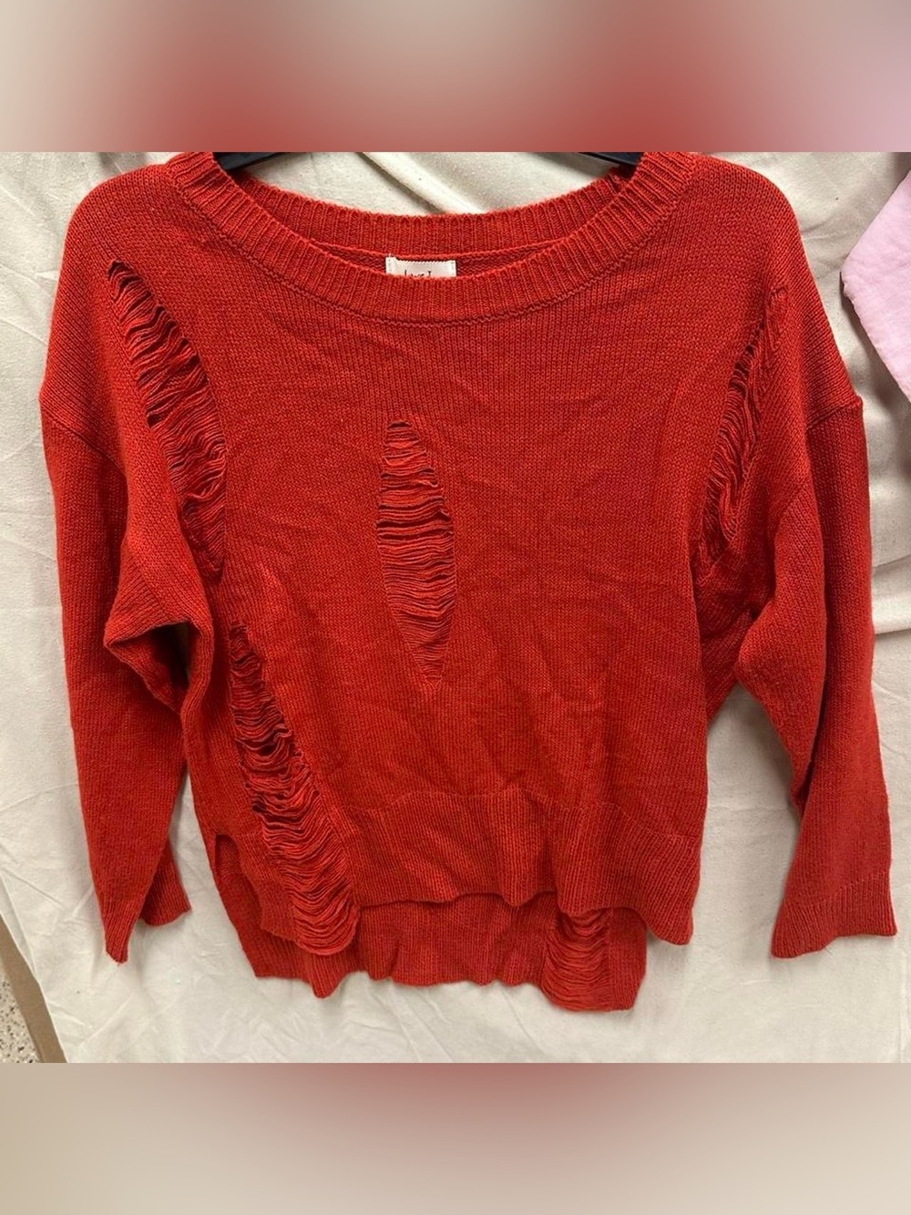 Long sleeve red ripped style sweater. Adult Size medium .